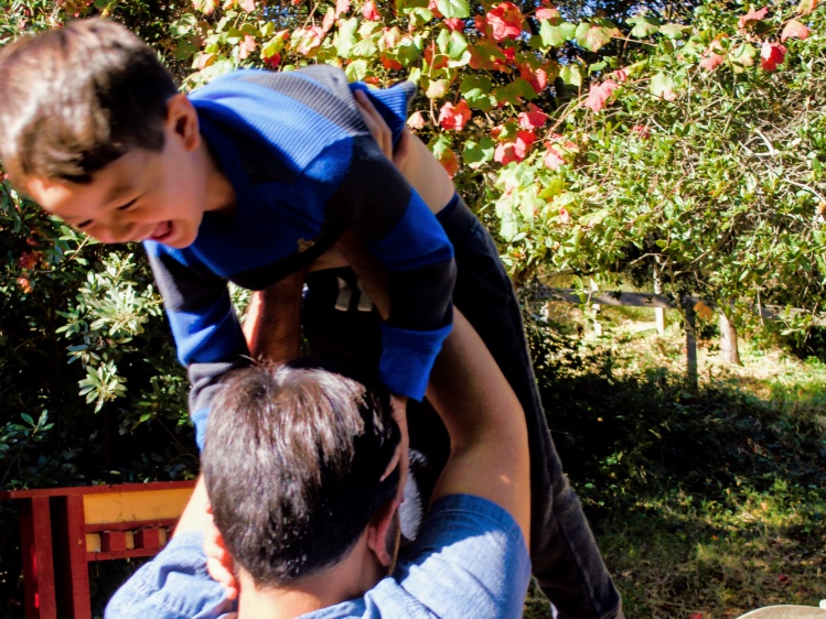 A father lifting his laughing child