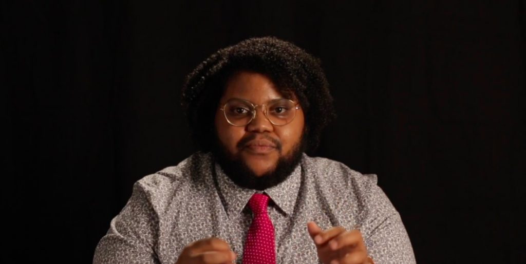 A young man speaking during a filmed interview