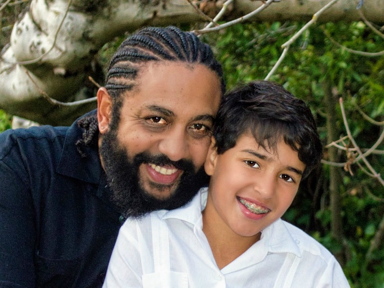 A father and son smiling together outdoors